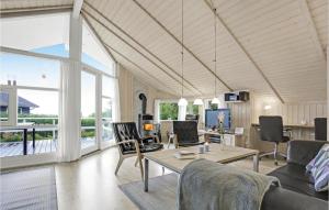 a living room filled with furniture and a large window at Three-Bedroom Holiday Home In Allinge in Allinge