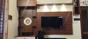 a large flat screen tv on a wall at Texas Heritage Guest house 4 Bedrooms in Trivandrum