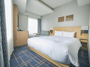 Postel nebo postele na pokoji v ubytování Hotel Traveltine Kyoto Kiyamachi