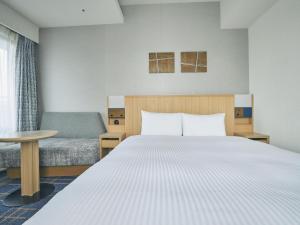 Postel nebo postele na pokoji v ubytování Hotel Traveltine Kyoto Kiyamachi