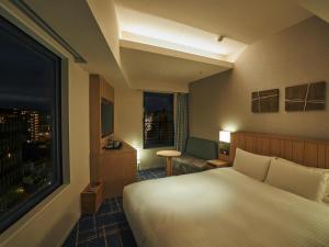 Postel nebo postele na pokoji v ubytování Hotel Traveltine Kyoto Kiyamachi