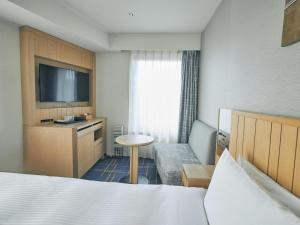 Postel nebo postele na pokoji v ubytování Hotel Traveltine Kyoto Kiyamachi
