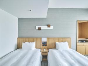 Postel nebo postele na pokoji v ubytování Hotel Traveltine Kyoto Kiyamachi