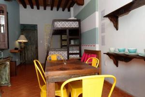 a dining room with a wooden table and yellow chairs at Estudio Centro histórico ciudad de morelia in Morelia