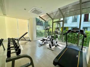 a gym with treadmills and exercise bikes in a room at Stunning sea view apartment with pool in Ao Nang Beach