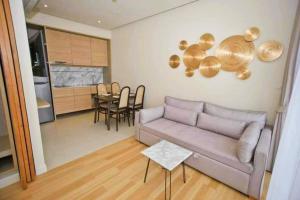 a living room with a couch and a table at Stunning sea view apartment with pool in Ao Nang Beach