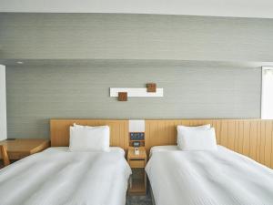 Postel nebo postele na pokoji v ubytování Hotel Traveltine Kyoto Kiyamachi