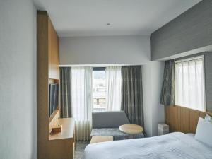 Postel nebo postele na pokoji v ubytování Hotel Traveltine Kyoto Kiyamachi