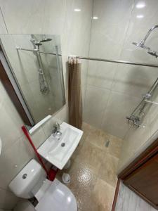 a bathroom with a sink and a toilet and a shower at Студия на двоих с потрясающим видом на море in Batumi