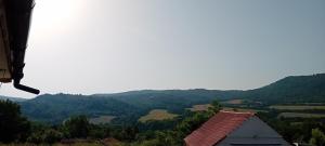 a view of a valley with a house and mountains at Salasuka Views in Dryanovo