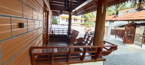 a porch of a house with a wooden railing at Texas Heritage Guest house 4 Bedrooms in Trivandrum +7 photos