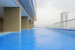 a view of a swimming pool in a building at Best Location and Strategic 2BR at Praxis Apartment By Travelio in Surabaya