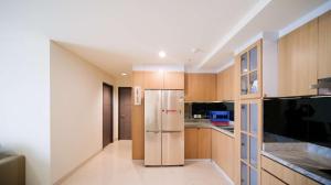 a kitchen with a stainless steel refrigerator at Best Location and Strategic 2BR at Praxis Apartment By Travelio in Surabaya