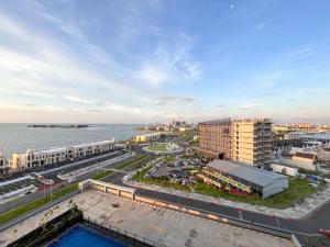 an aerial view of a city and the water at Best Deal Studio Room at Delft Ciputra Makassar Apartment By Travelio in Sungguminasa