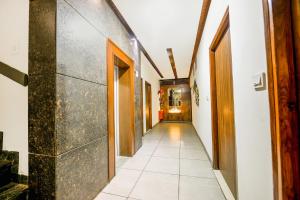 a hallway with a tile floor and a long corridor at FabHotel Nanda Civil Lines in Ludhiana