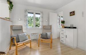 Neksøにある3 Bedroom Cozy Home In Nexøのリビングルーム(椅子2脚、ドレッサー付)