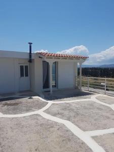 a small white building with a roof on top at Cute&Quiet Studio Loutraki in Loutraki