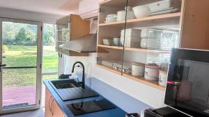 a kitchen with a sink and a counter top at Bush meets Beach in Mossy Point