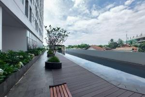 a balcony of a building with a bench on it at Minimalist and Strategic Studio at Serpong Garden Apartment By Travelio in Tangerang +5 photos