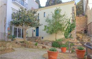 a house with orange pots in front of it at Cozy Apartment In Tossa De Mar, Girona in Tossa de Mar