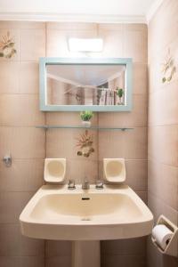 a bathroom with a sink and a mirror at Modern City Apt in the Heart of Heraklion in Heraklio Town