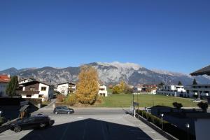 una strada in una città con montagne sullo sfondo di Gasthof Götznerhof a Innsbruck