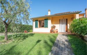 a house with a green lawn in front of it at Beautiful Home In Lajatico -Pi- in Laiatico +19 photos