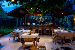 a restaurant with tables and a bar in the background at Kaya Villas Exclusive in Kayakoy