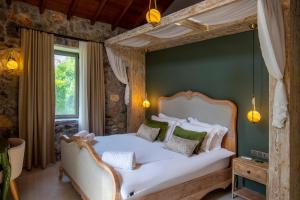 a bedroom with a bed with a canopy at Kaya Villas Exclusive in Kayakoy