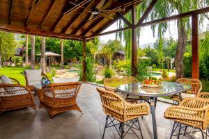 an outdoor patio with a glass table and chairs at Kaya Villas Exclusive in Kayakoy