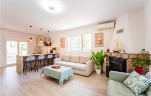 a living room with a couch and a table at Beautiful Home In Torrent in Torrent