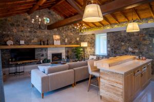 a living room with a couch and a fireplace at Kaya Villas Exclusive in Kayakoy