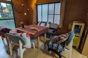 a dining room with a table and some chairs at Sakurah in Sakura