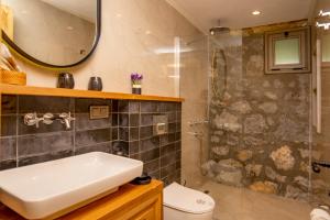 a bathroom with a sink and a shower at Kaya Villas Exclusive in Kayakoy