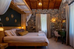 a bedroom with a large bed in a room at Kaya Villas Exclusive in Kayakoy +37 photos