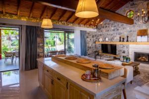 a kitchen with a fireplace and a table with pies on it at Kaya Villas Exclusive in Kayakoy