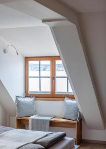 a bedroom with two beds and a window at Ferienwohnungen SEEELF - Luv Stay in Überlingen