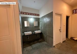 a bathroom with two sinks on a wall at Pepper Corn Retreat By Travent Mug in Sakleshpur