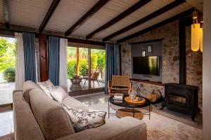 a living room with a couch and a fireplace at Kaya Villas Exclusive in Kayakoy