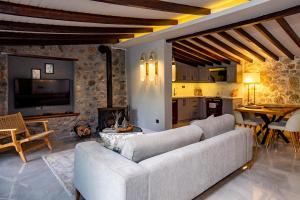 a living room with a couch and a kitchen at Kaya Villas Exclusive in Kayakoy