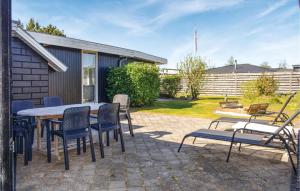 a patio with a table and chairs in a yard at Holiday Home Ydunvej Ebeltoft in Ebeltoft +24 photos