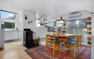 a kitchen and dining room with a table and chairs at Holiday Home Ydunvej Ebeltoft in Ebeltoft