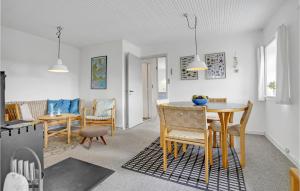 una sala da pranzo e un soggiorno con tavolo e sedie di Holiday Home Tranebærvej Oksbøl Iii a Vejers Strand