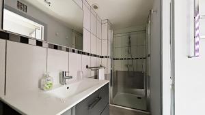 a white bathroom with a sink and a shower at Les Calins d'Honfleur in Honfleur +44 photos