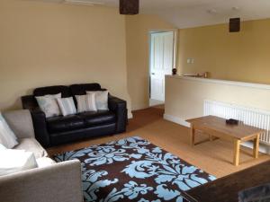 a living room with a couch and a coffee table at Duken Hof Ferienhaus in Quatford