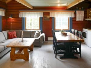 a living room with a table and a couch at 5 person holiday home in Hemsedal-By Traum in Hemsedal