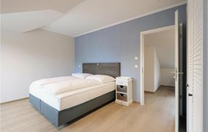 une chambre avec un lit et un mur bleu dans l'établissement Baltischer Hof Apartment 68, à Boltenhagen