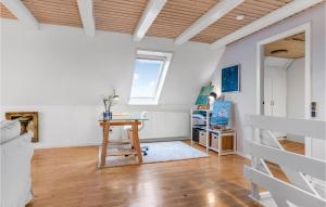a living room with a table and a window at 4 Bedroom Nice Home In Skagen in Skagen