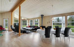 a living room with a table and chairs at Holiday Home Sletten Hadsund Xii in Helberskov