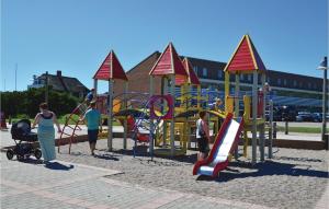 a group of people playing in a playground at Holiday Home Ringkobing Iii in Søndervig